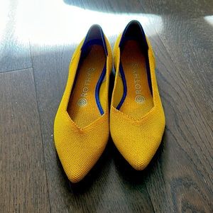 Rothy pointed to flats in yellow.